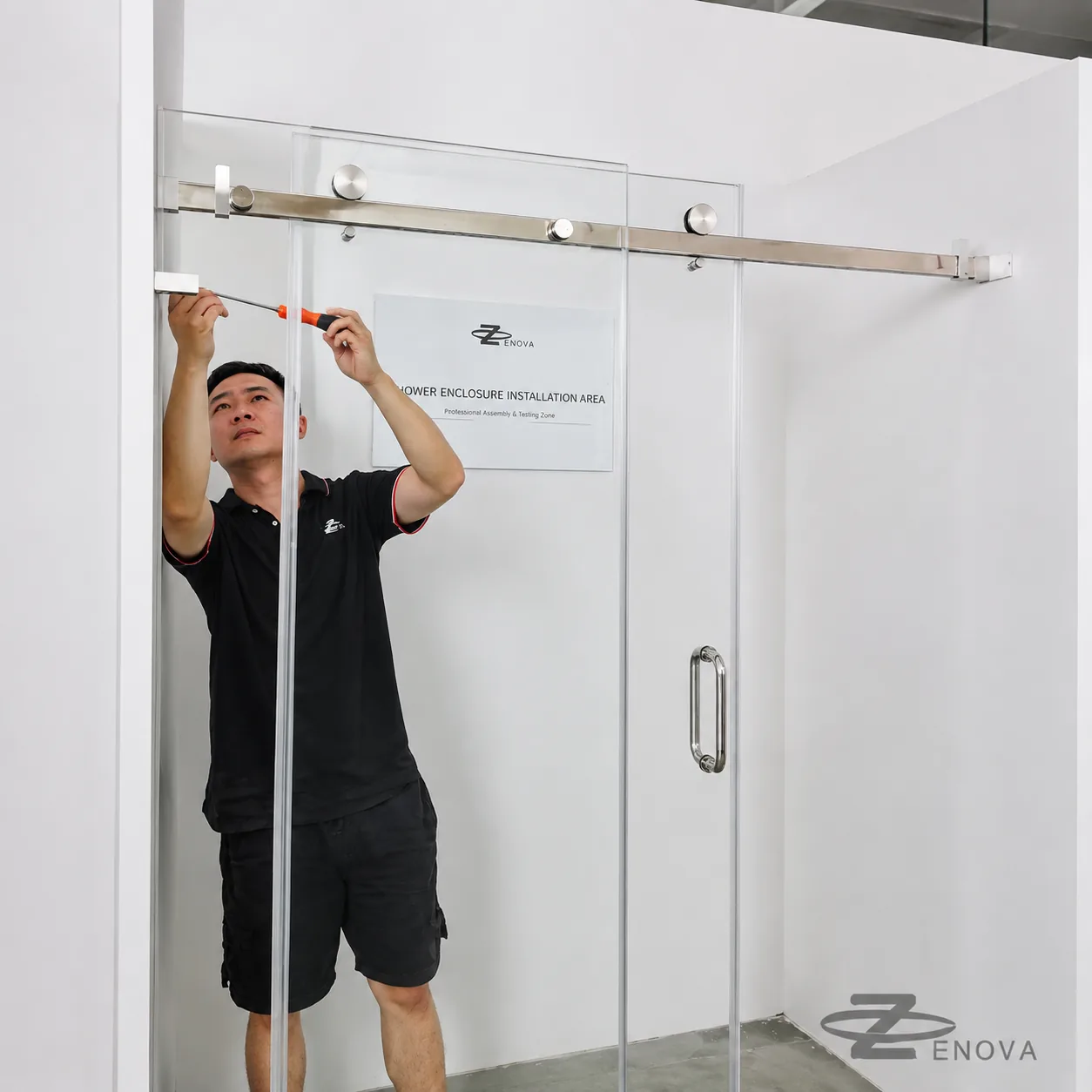 Trial-fitting a curved sliding shower enclosure in the Zenova installation area